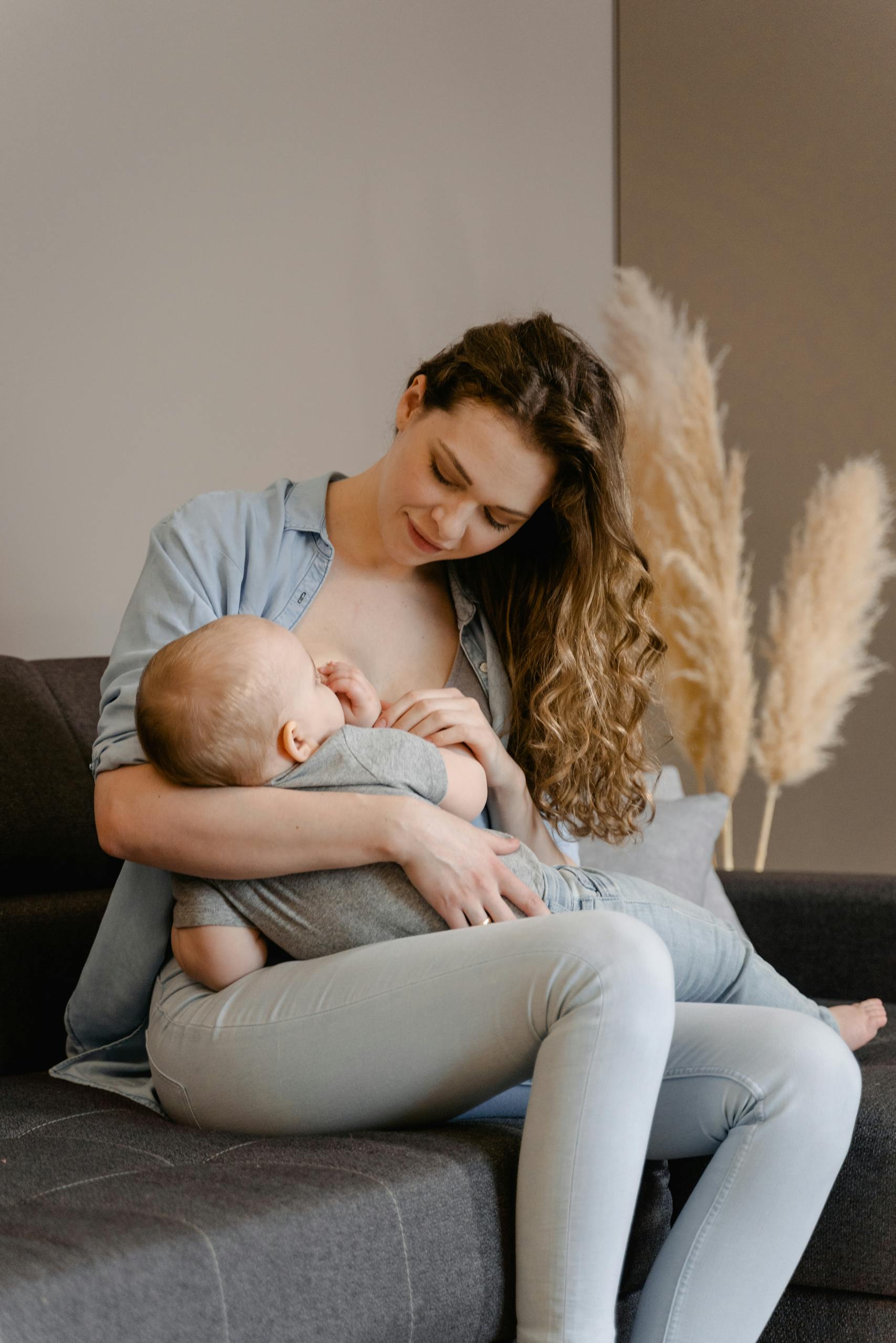 A tender moment of a mother breastfeeding her baby while sleep training.